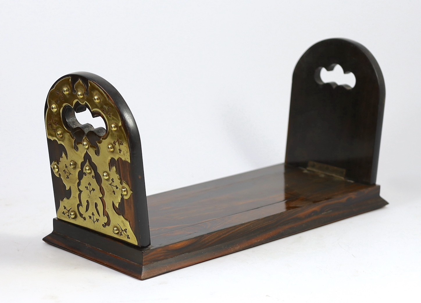 A Victorian brass mounted coromandel wood stationery casket with matching blotter, a similar book rack and gallery tray, 26cm